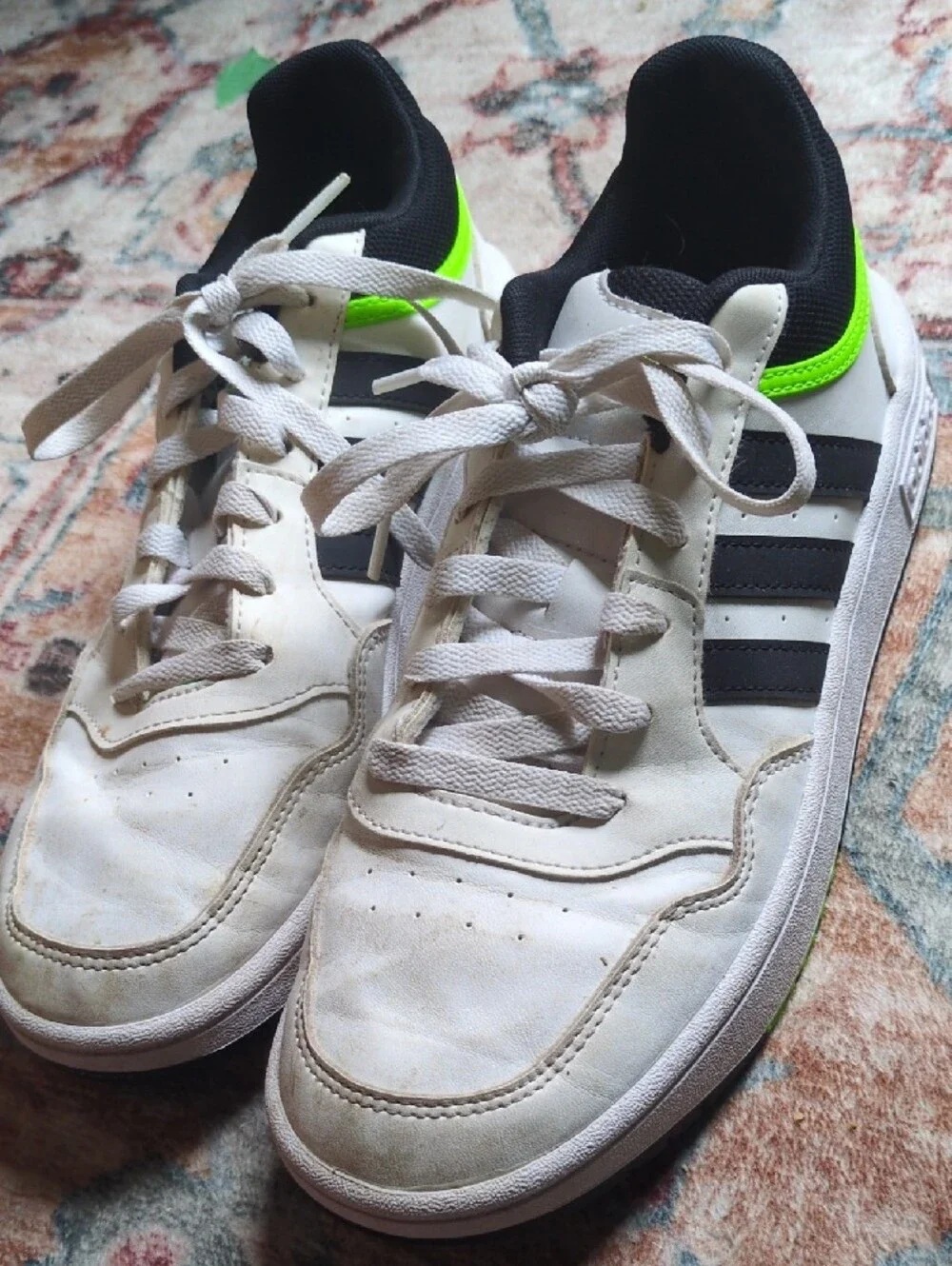 White Adidas Sneakers with Black Stripes and Neon Green Accent